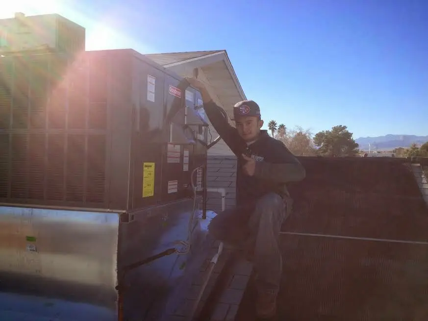 HVAC technician performing Boiler Repair on a rooftop unit in Bethesda